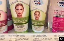 FILE—Creams promising fairer and lighter skin are displayed on shelves, July 3, 2020, in Dubai, United Arab Emirates.