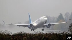 A United Airlines Boeing 737 Max airplane takes off in the rain, Dec. 11, 2019, at Renton Municipal Airport in Renton, Wash.