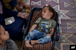 Displaced infant Abdel-Rahman Abu El-Jedian, who suffers from polio, sleeps at a makeshift tent camp in Deir al-Balah, central Gaza Strip, on Aug. 27, 2024.