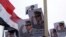 FILE - Posters of Army Chief General Abdel Fattah al-Sisi are seen as supporters of the army protest against ousted Islamist President Mohamed Morsi.