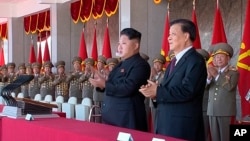 FILE - North Korean leader Kim Jong Un, center, along with Liu Yunshan, China's Communist Party's No. 5 leader, second right, claps hands during the ceremony to mark the 70th anniversary of the country's ruling party in Pyongyang, October 10, 2015.