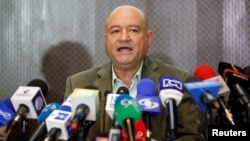 FILE - Carlos Lozada, a member of the Revolutionary Armed Forces of Colombia (FARC), gestures during a news conference in Bogota, Colombia, March 6, 2017.