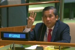 Myanmar's ambassador to the U.N. Kyaw Moe Tun holds up three fingers at the end of his speech to the General Assembly at the U.N. in New York City, Feb. 26, 2021.