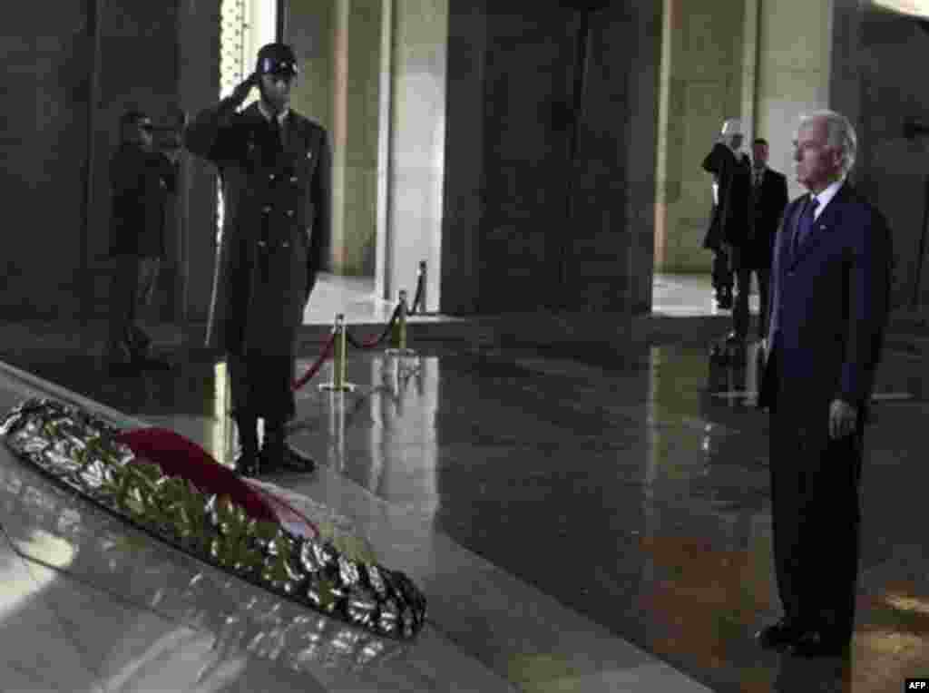 U. S. Vice President Joe Biden is flanked by a Turkish army officer during a wreath laying ceremony at the mausoleum of Kemal Ataturk, the founder of modern Turkey, in Ankara, Turkey, Friday, Dec. 2, 2011. Biden called on Turkey to impose new sanctions ag