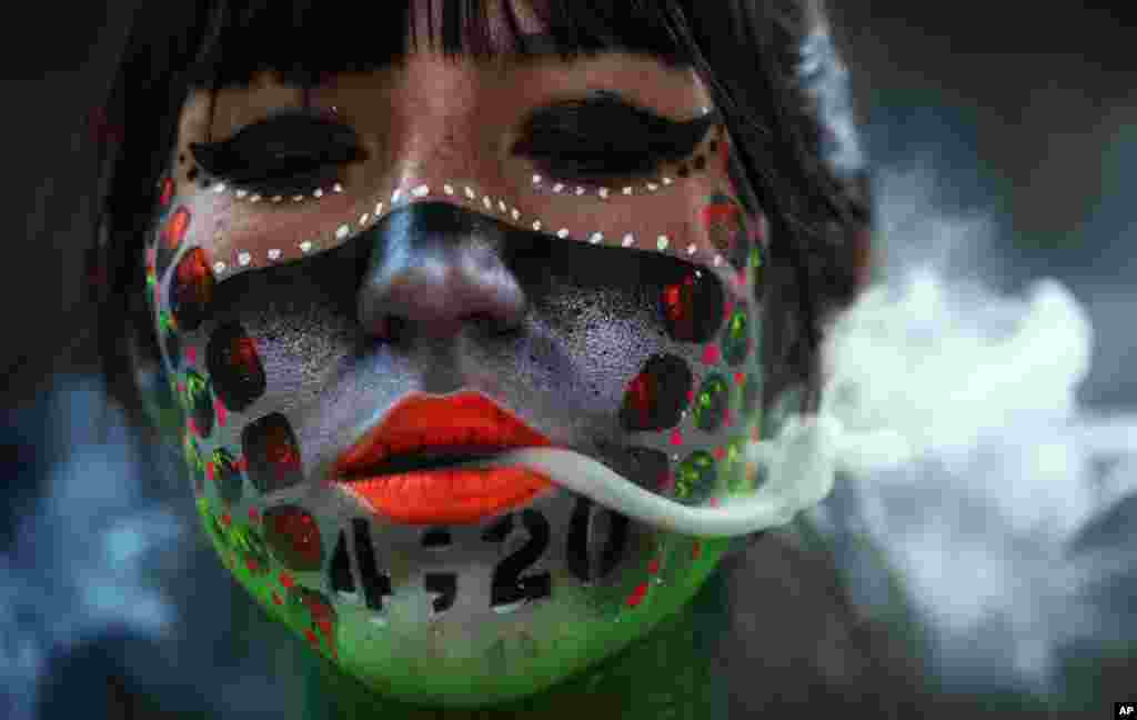 Ana Mendez Casteñeda smokes marijuana during "Fumaton 420" outside the national Senate in Mexico City, April 20, 2021.