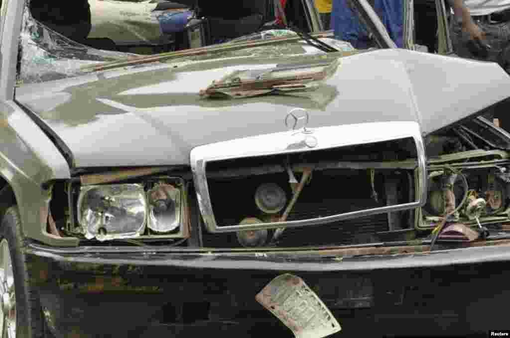 The force of the bomb blast tore apart this car in Kano, Nigeria, Tuesday, July. 30, 2013.