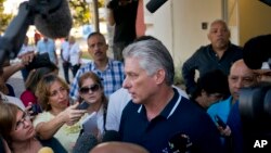 Cuba's President Miguel Diaz-Canel talks to the press after voting in a referendum to approve or reject the new constitution in Havana, Cuba, Sunday, Feb. 24, 2019. 