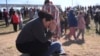 Dasia Pleitez prays as she waits for her daughter at a unification site following a shooting at the Antioch High School in Nashville, Tennessee, Jan. 22, 2025.