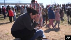 Dasia Pleitez prays as she waits for her daughter at a unification site following a shooting at the Antioch High School in Nashville, Tennessee, Jan. 22, 2025.