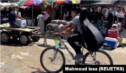 In this frame captured from video, Palestinian teenager Youssef Saad rides his bicycle with his musical instrument strapped to his back amid Israel-Hamas conflict, in Jabalia refugee camp in the northern Gaza Strip September 2, 2024. (REUTERS/Mahmoud Issa)