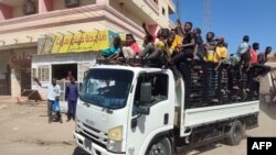 FILE - Sudanese enroled youth stand in the back of a truck in Gedaref city, Sudan, on January 14, 2024 amid the ongoing conflict in Sudan between the army and paramilitaries.