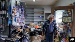 Kenny Ransbottom walks through debris inside his auto parts store after an earthquake in Rio Dell, California, Dec. 20, 2022. 