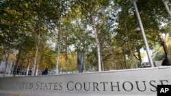 FILE - A U.S. Courthouse is seen in Seattle, Washington, fronted by a tree-lined courtyard, Nov. 6, 2019. Many U.S. immigration courts are temporarily closing or curtailing operations as the nation continues to grapple with the coronavirus pandemic.