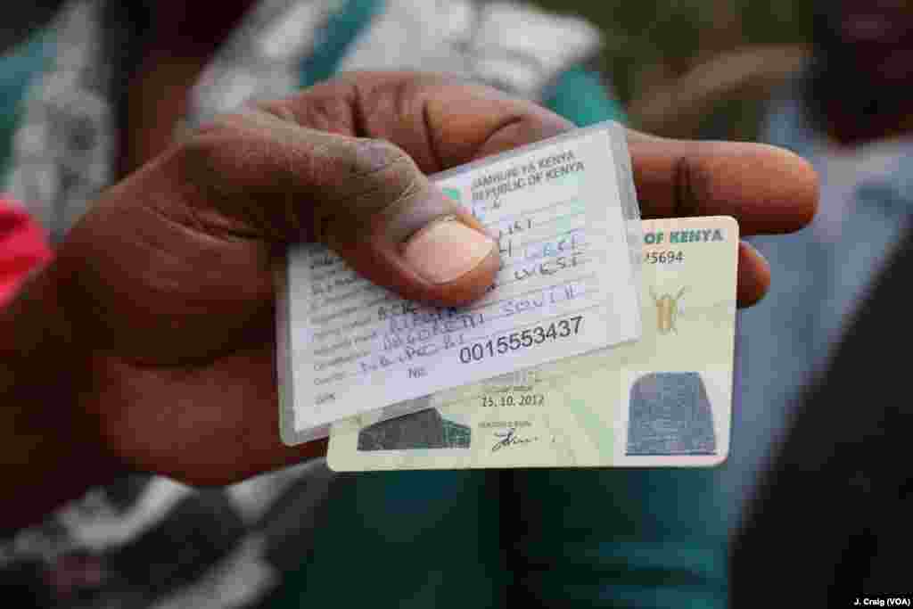 A voter in Dagoretti shows his national and voter IDs while standing in line for the second presidential election, Oct. 26, 2017.