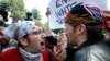 A counterprotester, left, confronts a supporter of President Donald Trump, Aug. 19, 2017, in Boston.