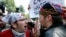 A counterprotester, left, confronts a supporter of President Donald Trump, Aug. 19, 2017, in Boston.