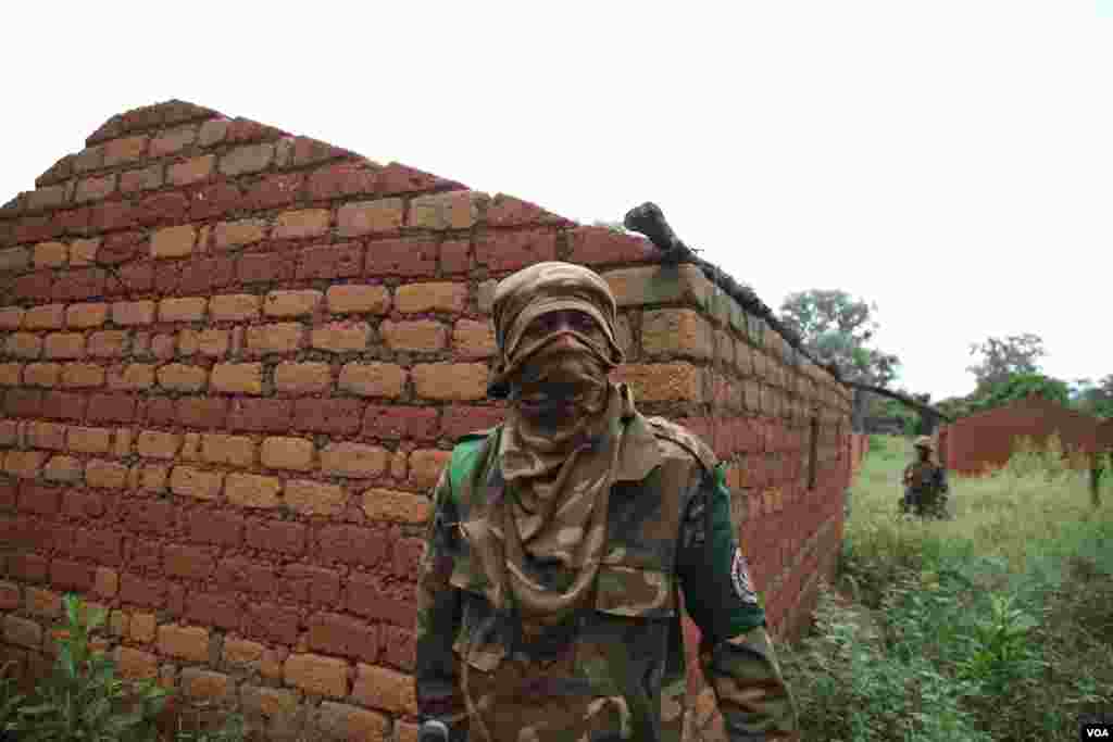 Regional peacekeepers at an abandoned village on the road south of Bossangoa, Nov. 13, 2013. (Hanna McNeish for VOA)