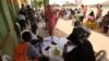 Health workers attend to people during a community COVID-19 coronavirus testing campaign in Abuja, Nigeria, on April 15, 2020.