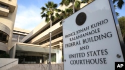 FILE - A sign for the Hawaii U.S. federal court stands outside the building in Honolulu on Wednesday morning, March 15, 2107. 