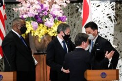 U.S. Secretary of State Antony Blinken (C-L) and Defense Secretary Lloyd Austin (L) leave a joint news conference with Japan's Foreign Minister Toshimitsu Motegi, (C-R), and Defense Minister Nobuo Kishi after meeting in Tokyo, Japan, March 16, 2021.