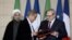 Chief Executive of Suez Environment, Jean-Louis Chaussade (R), Iranian Energy Vice-Minister, Alireza Daemi (L), Iranian President Hassan Rouhani (Background L), and French President Francois Hollande attend a bilateral agreements session in Paris, Jan. 28, 2016.