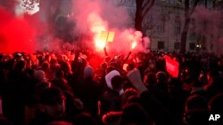 Demonstrators shout slogans and light flares during a demonstration against new COVID-19 restrictions in Vienna, Austria, Nov.20, 2021.