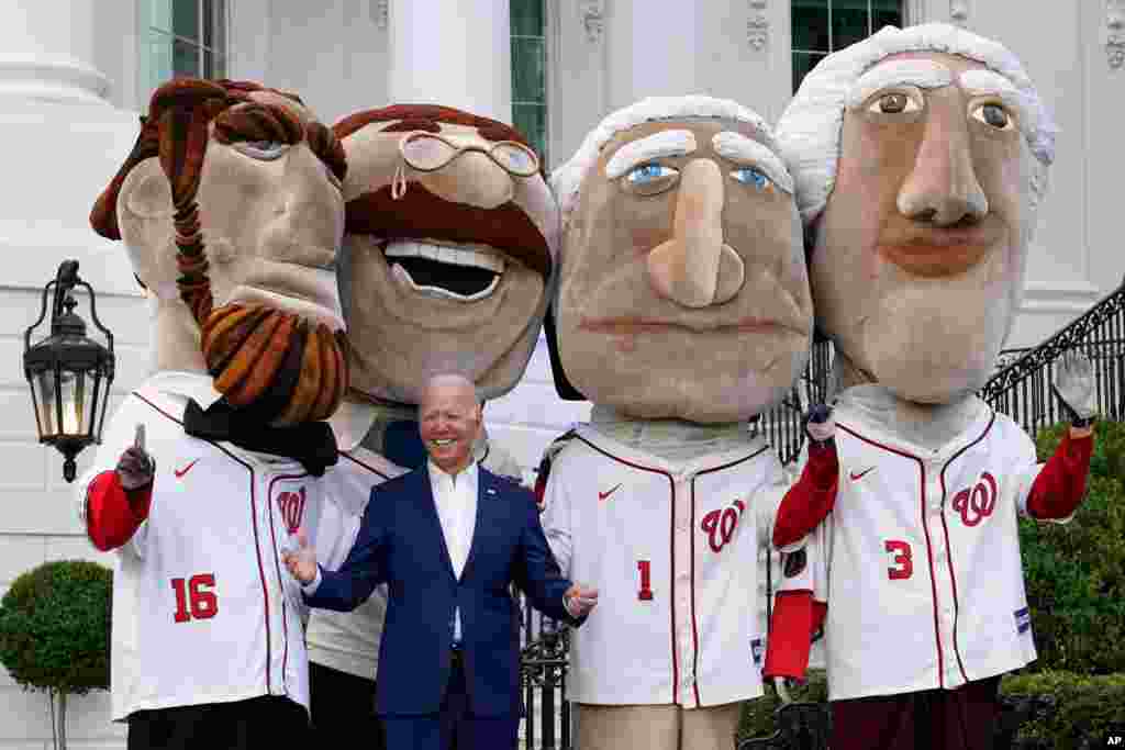 President Joe Biden visits with members of the Washington Nationals' Racing Presidents after speaking at an Independence Day celebration on the South Lawn of the White House, July 4, 2021, in Washington.