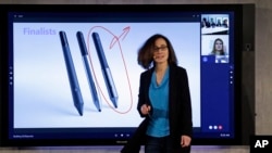 FILE - Microsoft's Hayete Gallot demonstrates a Surface Hub product at the company's headquarters, Jan. 21, 2015, in Redmond, Washington.