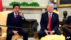 FILE - President Donald Trump meets with Japanese Prime Minister Shinzo Abe in the Oval Office of the White House in Washington, June 7, 2018. 