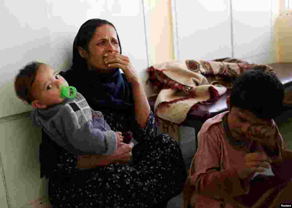 A woman reacts at the Indira Gandhi Children&#39;s hospital after explosions at the Sardar Mohammad Daud Khan National Military Hospital in Kabul, Afghanistan. The children&#39;s hospital was not attacked.