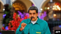 This handout picture released by the Venezuelan Presidency shows Venezuela's President Nicolas Maduro speaking during a televised announcement at the Miraflores Presidential Palace in Caracas, on Nov. 15, 2020.