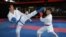 This picture taken on May 11, 2021 shows Afghan-born refugee and karate competitor Asif Sultani (L) training on the outskirts of Sydney as he competes for a place on the Refugee Olympic Team at the…