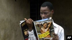 FILE: Gay activist Bisi Alimi, 27, looks at a copy of Gay Times magazine in front of his house in Lagos, Nigeria, Wednesday, Oct. 11, 2006