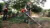 Soldiers clean a backyard to prevent the spread of yellow fever in San Lorenzo, Paraguay, Feb 19, 2008.