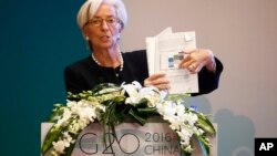 International Monetary Fund (IMF) Managing Director Christine Lagarde holds a document report while speaking during a session of the G20 High-Level Seminar on Structural Reform, proceeding the G20 Finance Ministers and Central Bank Governors Meeting at th