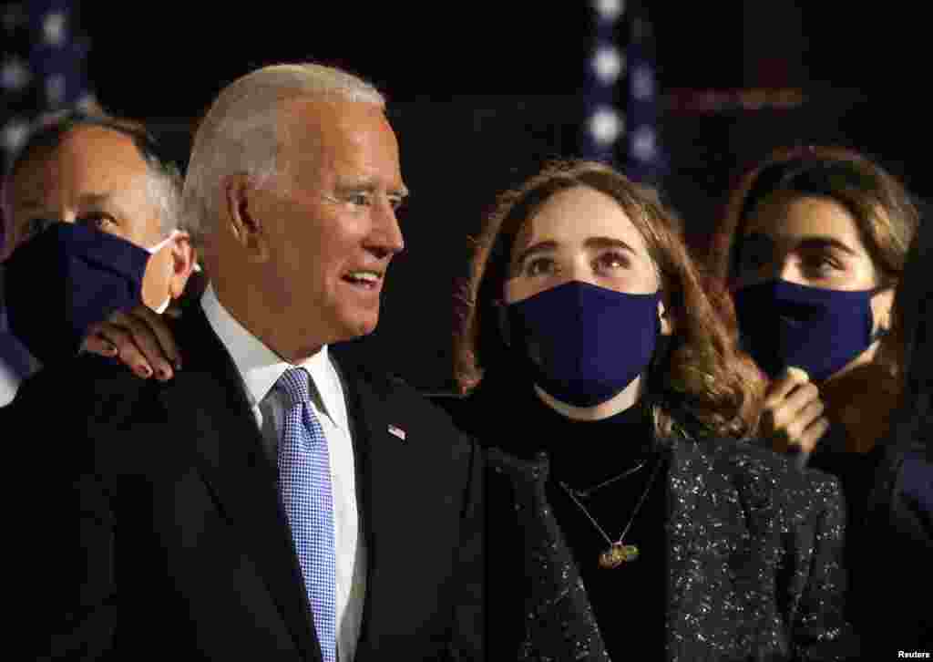 Democratic 2020 U.S. presidential nominee Joe Biden is embraced by his granddaughter after speaking during his election rally.