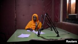 Radio Shabelle presenters reads the news at station headquarters, Mogadishu, Dec. 8, 2012.