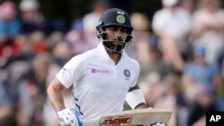 In this March 1, 2020, file photo, India's Virat Kohli runs a single while batting during play on day two of the second cricket test between New Zealand and India at Hagley Oval in Christchurch, New Zealand. 