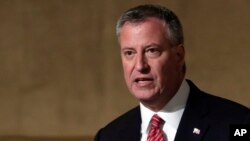 FILE - New York Mayor Bill de Blasio supports access to the city’s single-sex public restrooms and other facilities based on an individual’s gender identity. He’s shown in 2014. 