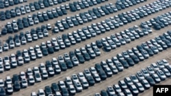 Electric (EVs) and hybrid vehicles wait to be transported in a distribution center of Chinese state-owned automobile manufacturer Changan in southwest China's Chongqing municipality, Jan. 12, 2025.