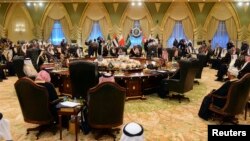 Heads of States of the Gulf Cooperation Council sit at a round table in Bayan Palace for the opening session of the 34th GCC Summit hosted by Kuwait, Dec. 10, 2013. 