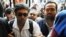 Mohamed Adel (R) is seen with Ahmed Maher (L), founder and former leader of the "April 6" movement, when Maher turned himself in at Abddein court in Cairo, Egypt, Nov. 30, 2013.