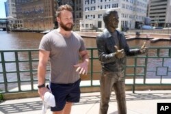 Jake Schneider talks about the Republican National Convention coming to Milwaukee, Wisconsin, next to the bronze Fonz statue on July 1, 2024, in Milwaukee.