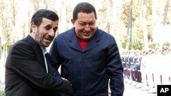 Iran's President Mahmoud Ahmadinejad (L) shakes hands with Venezuela's President Hugo Chavez during an official welcoming ceremony in Tehran (file photo)