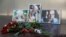 FILE - Photographs of journalists, (R-L) Orhan Dzhemal, Kirill Radchenko and Alexander Rastorguyev, who were recently killed in Central African Republic by unidentified assailants, are on display outside the Central House of Journalists in Moscow, Aug. 1, 2018. 