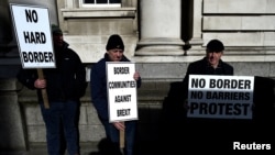 FILE - Anti-Brexit campaigners Borders Against Brexit protest outside Irish government buildings in Dublin, Ireland, April 25, 2017. 