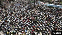 Protesters conduct Friday Prayers in Tahrir square in Cairo. Thousands of Egyptians converged on Cairo's Tahrir square on Friday in what organizers called a "second revolution" to push for deeper reforms and a speedy trial for ousted President Hosni Mubar
