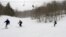 In this March 15, 2018, photo, skiers head down a slope at Mad River Glen in Fayston, Vt. Three successive March snowstorms have provided good conditions for late-season skiing.
