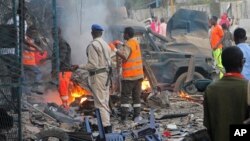 Tentara Somali memeriksa rongsokan kendaraan setelah bom meledak di Mogadishu, 28 Oktober 2017. 