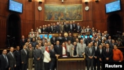 Members of the assembly writing Egypt's new constitution pose for a group photo after finishing their vote at the Shura Council in Cairo December 1, 2013. 